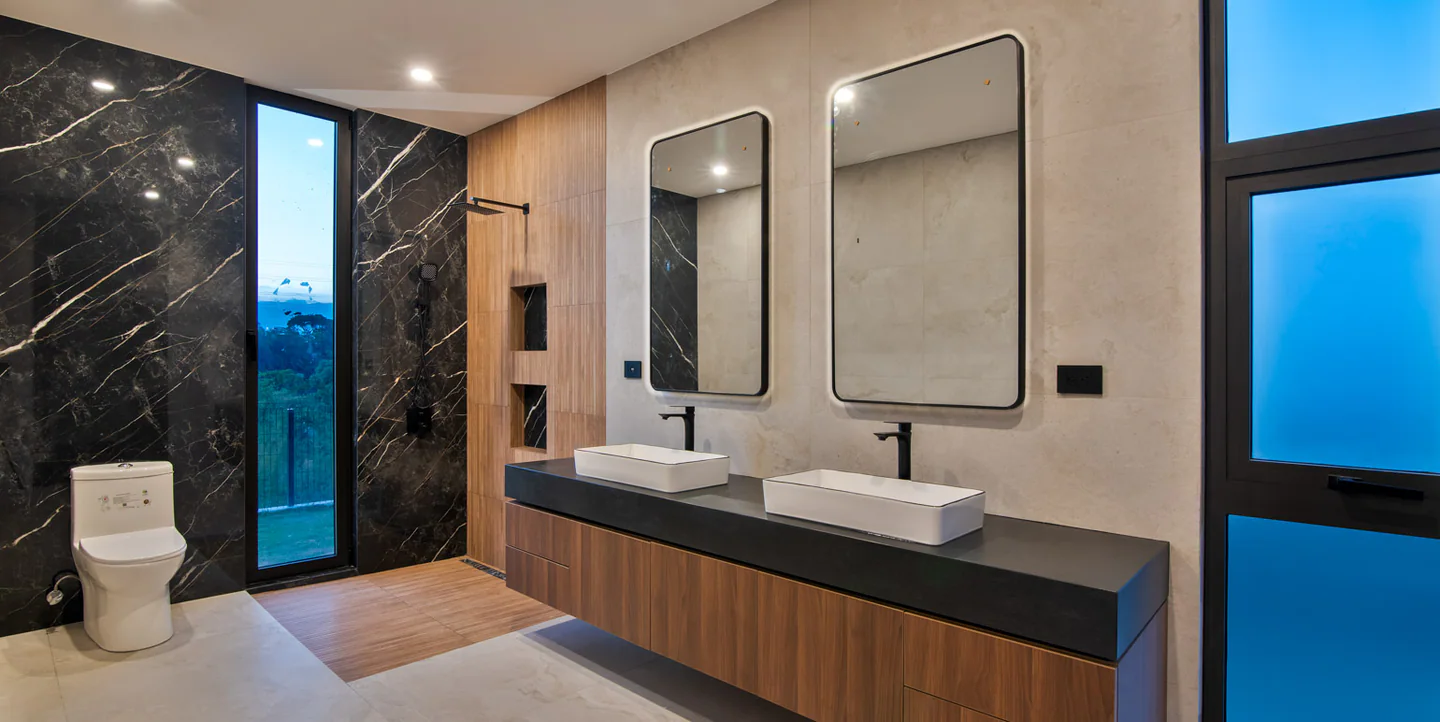 Valle del Sol 400 primary bathroom with dark stone and wood